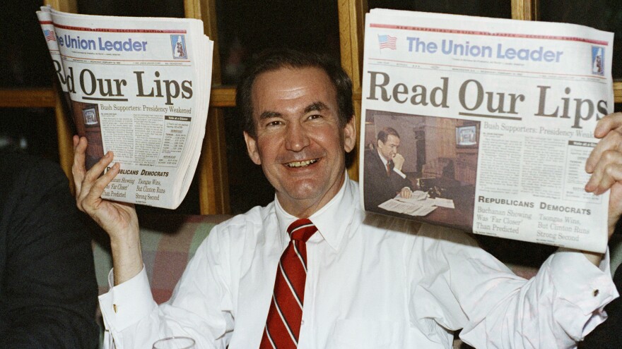 After claiming over one-third of the vote in the 1992 New Hampshire GOP primary, candidate Pat Buchanan holds up copies of a local newspaper with a headline evoking a broken campaign promise of incumbent Republican President George H.W. Bush.