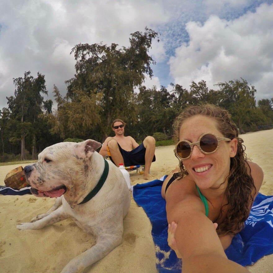 Mary Finley, Travis Sherman and Tonka at the beach.  'I'm fearful of the world that we are making for ourselves,' Travis said. 'That's why I don't want to have children.'