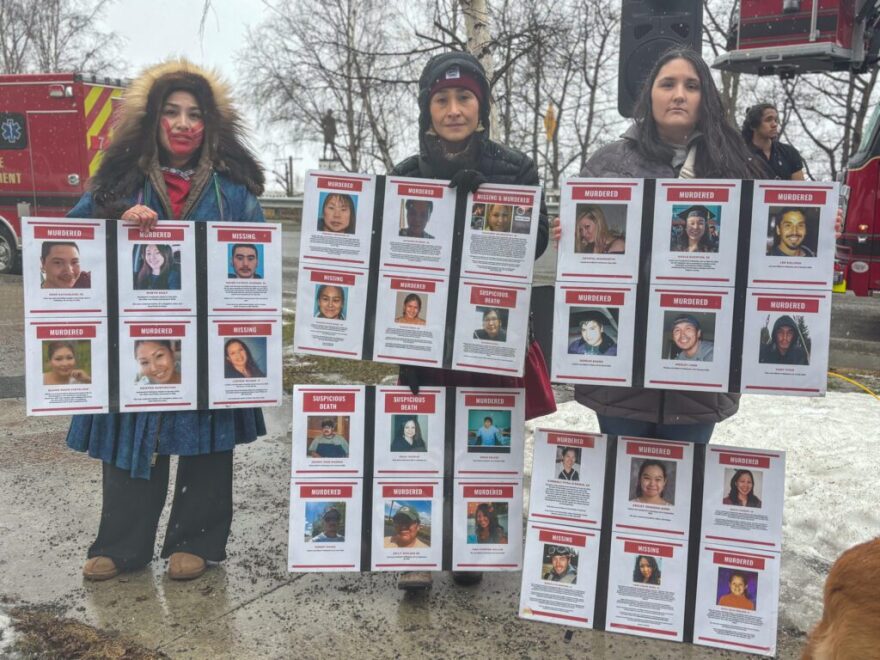 Missing and Murdered Indigenous People advocate Antonia Commack, left, and colleagues hold signs with missing people at a Ceremony or Remembrance event in Anchorage.
