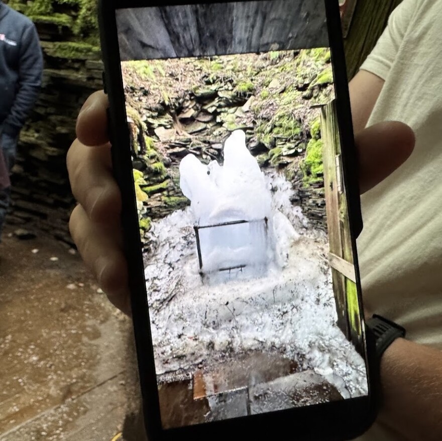 One of the tour guides at the Coudersport Ice Mine showed the group a picture of what the mine looked like on Memorial Day. Ice overflowed from the mine and onto the viewing platform.