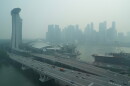 A thick haze obscures the skyline behind the Central Business District area in Singapore, Friday, Oct. 9, 2026. (AP Photo/David Hu)