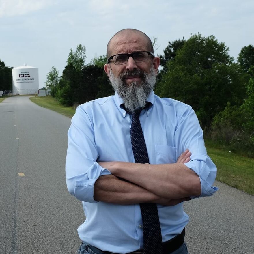 photo of Marty Rosenbluth standing in front of a water tower