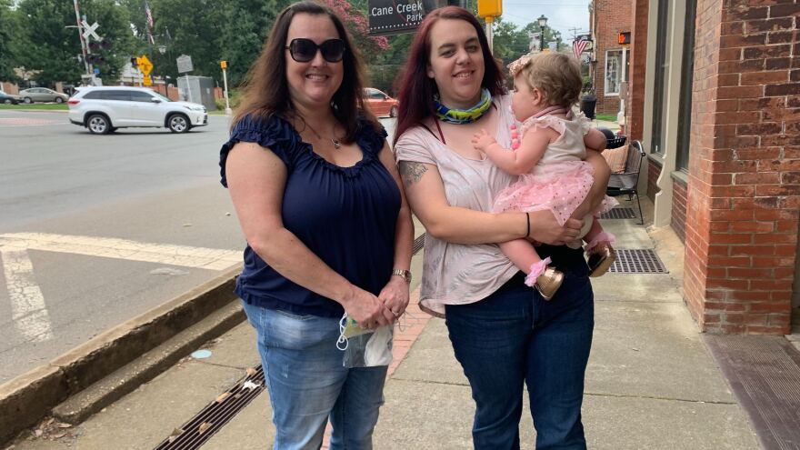 Grandmother Cindy Carroll, daughter Lauren Harrah and 11-month-old granddaughter Austin are headed to a local antique store in the historic district of Waxhaw, N.C. Carroll and Harrah aren't totally sold on President Trump, but they will vote for him over Joe Biden.