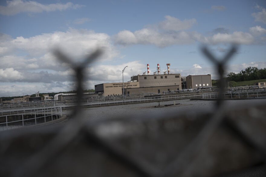 The Metropolitan District Hartford Water Pollution Plant, which houses a sewage sludge incinerator, is seen behind a fence in the South Meadows neighborhood of Hartford, Conn., Tuesday, Sept. 13, 2022. In 2021, the Metropolitan District was fined $298,000 for pollution violations at its sewage sludge incineration facilities.