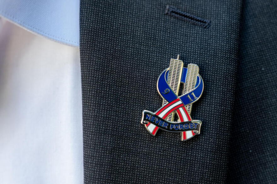 Brett Eagleson, 40, President of 9/11 Justice, wears a 9/11 pinduring a press conference demanding accountability regarding the Kingdom of Saudi Arabia's role in the 9/11 terrorist attacks, Tuesday, Sept. 8, 2026, in New York. (Adam Gray/AP)