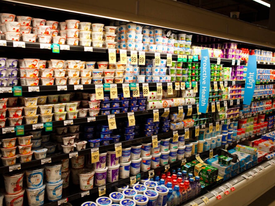 A supermarket's dairy case with shelves of yogurt.