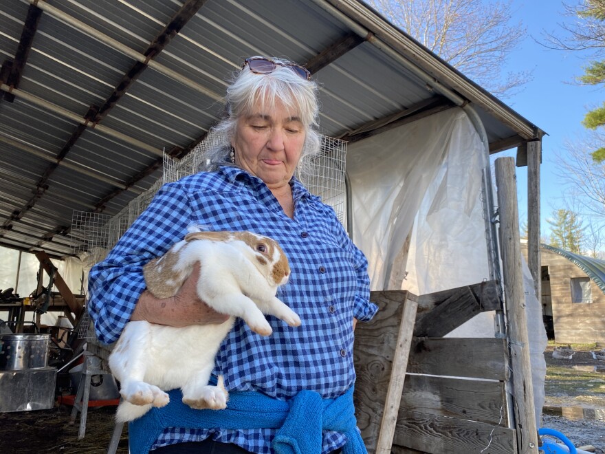 Kathy Shaw of Valley View Farm hangs out with one of the rabbits she raises for meat at her Auburn farm.