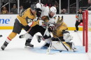 Chicago Blackhawks' Jordan Greenway (12) falls into Vegas Golden Knights goaltender Carter Hart (79) during the first period of an NHL hockey game Tuesday, Sept. 29, 2026, in Las Vegas. (AP Photo/John Locher)