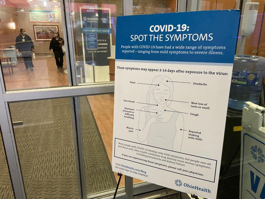 A sign inside an OhioHealth facility provides information on COVID-19 symptoms.