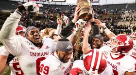 Indiana players celebrate with the Old Oaken Bucket after defeating Purdue on Nov. 30, 2019 in West Lafayette.