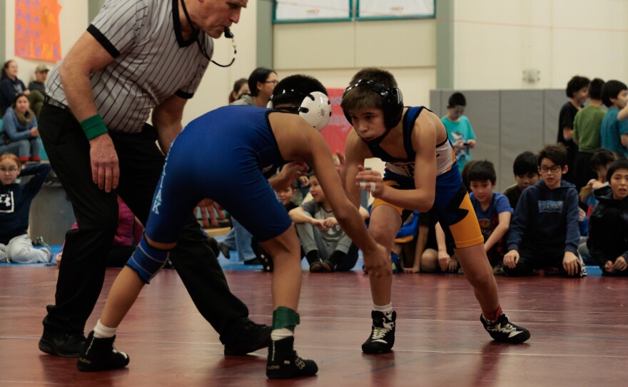 Bethel Junior High wrestler Cole Iverson at the start of a match.