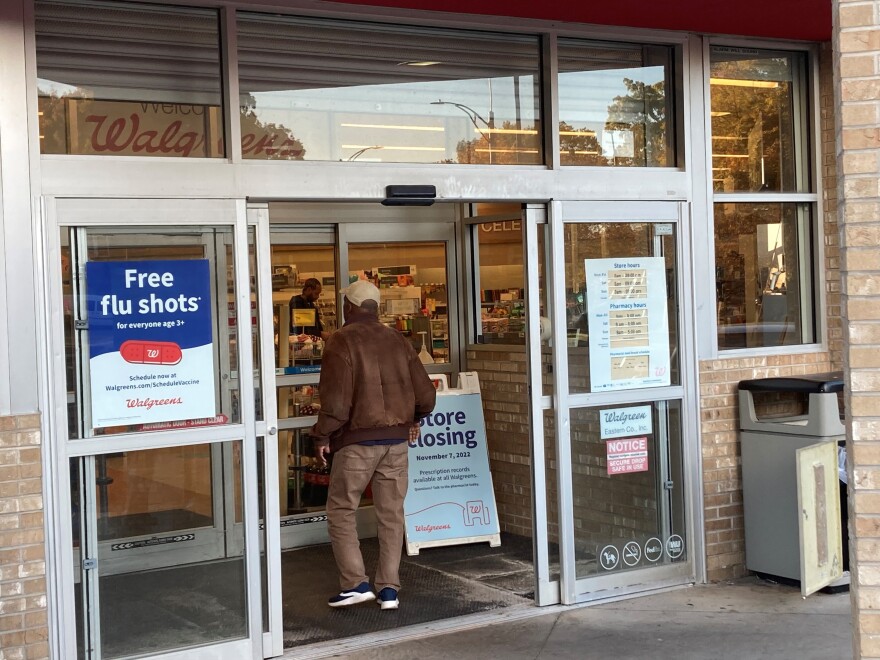 A customer walks into the Walgreens at Thurston and Brooks on Friday, Oct. 21, 2022, and past a folding sign announcing the store's impending Nov. 7 closing.