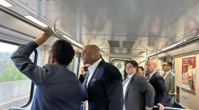 Mayor Brandon Scott points out sights during a subway ride with Gov. Wes Moore.