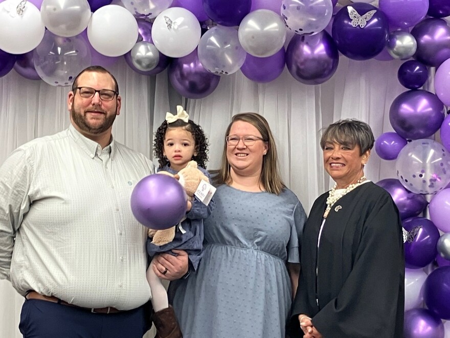 Andrew Smith and his wife Erin celebrate newly adopted Adleigh Mae with Judge Norma Kauzlarich Nov. 21, 2025.