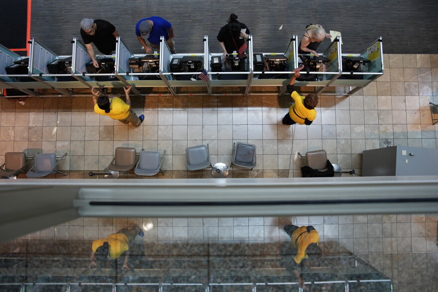 People vote in the Nevada primary at a polling place, Tuesday, June 11, 2024, in Henderson, Nev.
