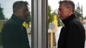 Commissioner of U.S. Customs and Border Protection Rodney Scott is reflected in a window as he speaks with an officer in a border crossing booth during a visit at the Point Roberts port of entry between the United States and Canada, Thursday, Oct. 22, 2026, in Point Roberts, Wash.
