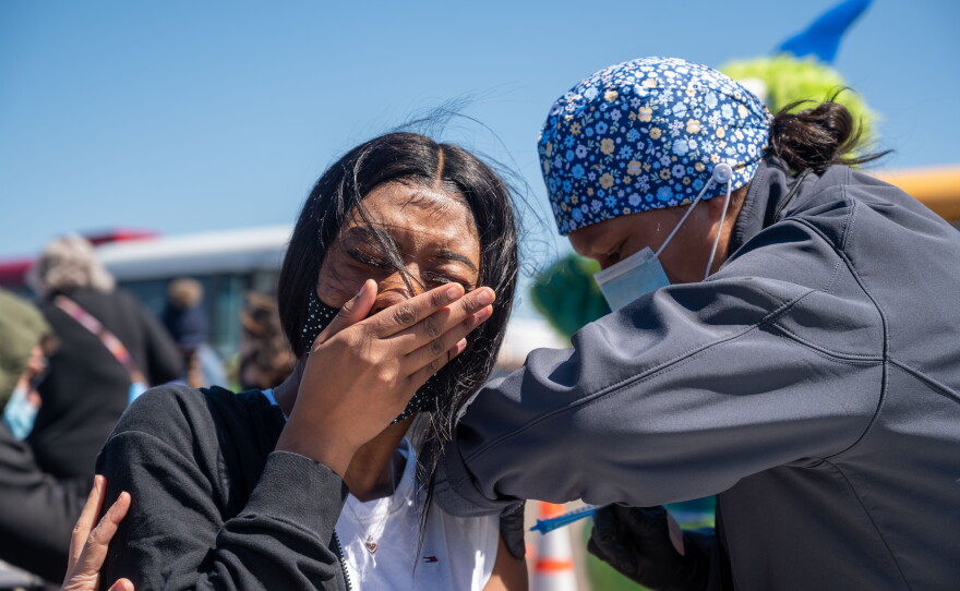 Nikela, an East Hartford High School senior, receives her first dose of a COVID-19 vaccine on April 26, 2021. East Hartford High School brought a bus of seniors to the Pratt & Whitney vaccination site to help get younger residents vaccinated.