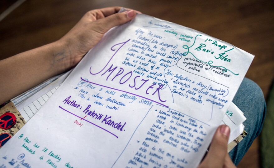 Prakriti Kandel holds the original manuscript for her book, <em>Imposter</em>, in which girls who get their periods also get superpowers.