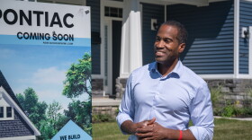 Congressman John James (R-MI 10) stands outside a newly-constructed home in Pontiac in September 2026.