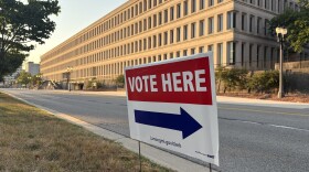 Vote here sign sits outside of a Lansing polling location.