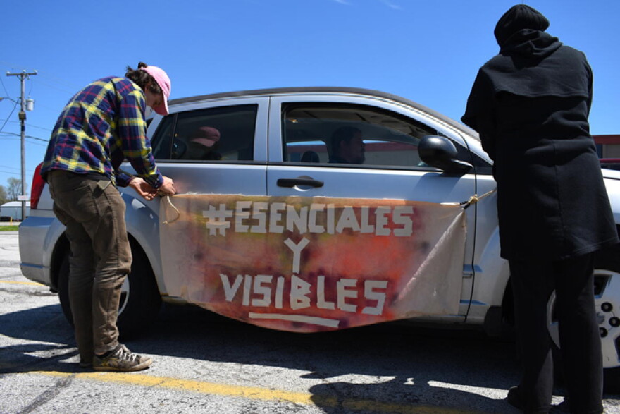 Demonstrators hang a banner from a car before the protest in Elkhart, Indiana.