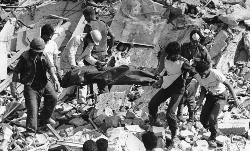 Rescue workers carry the body of a U.S. Marine killed in the Oct. 23, 1983, bombing of the Marine Operations Center in Beirut, Lebanon. The attack killed 241 American service members.