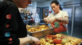 Rosaline Burr (center), program coordinator at Dimitri House, and volunteer Krystina Herdzik prepare for a Thanksgiving lunch to be served the next day for guests at Dimitri House on Tuesday, November 25, 2025. Dimitri House provides outreach to people experiencing poverty and homelessness in Rochester through its food cupboard and hot lunch program, both of which have seen an increase in demand over the past year.