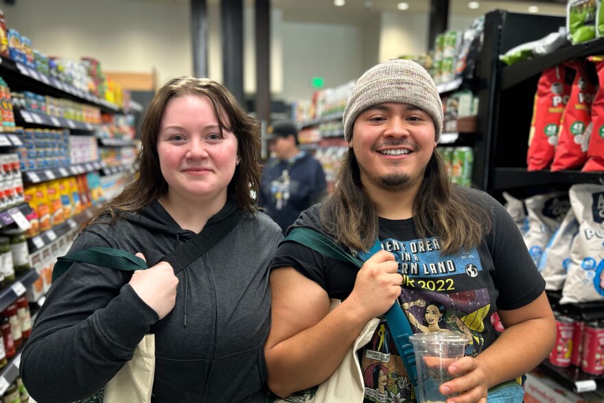 Shoppers Kaylee Smart (left) and Andres Medina said the fact that at least 20% of Wasatch Food Co-op’s items are from local producers is the main draw for them to shop at the store’s May 20, 2026, grand opening.