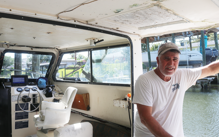 Mark Tryon stands inside his boat on Friday, May 16, 2025. Kylie Williams/WUFT News