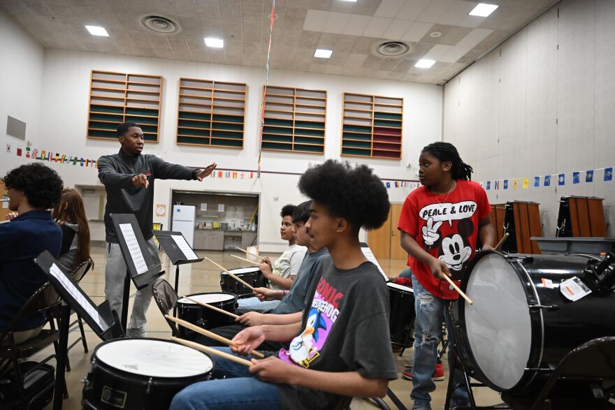Band camp instructor Curtis Akeem (left) works with some of the drummers at Dr. Etheldra Davis Fairview Elementary School.
