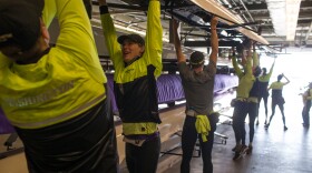 The University of Washington Men's Rowing team prepares for an early morning practice.