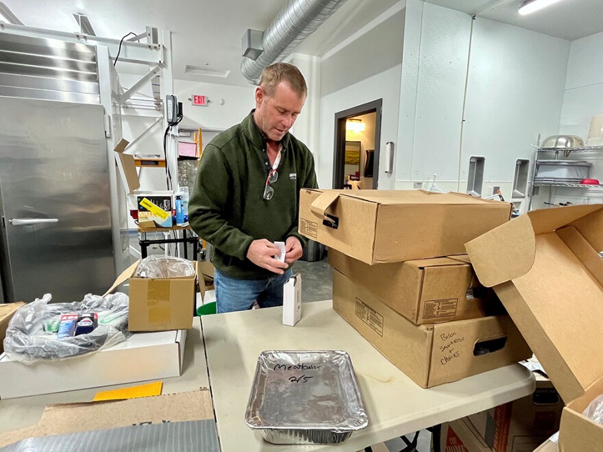 Rancher Lamont Herman takes inventory of boxes of frozen meat at Montana Prime Meats