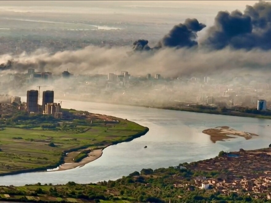 An aerial view of black smoke covering the sky above the capital Khartoum. Explosions and gunfire resounded in Sudan's capital on April 20, as fighting between the forces of two rival generals showed no signs of abating ahead of festivities marking the end of Ramadan.