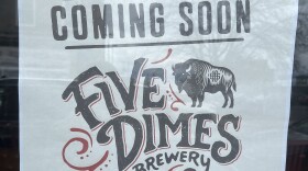 Sign hanging on the window of the former Red Tank Brewing space