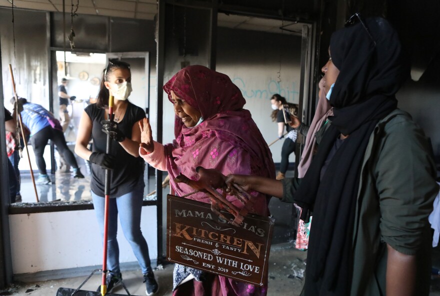 Safia Munye exits the remains of her restaurant, Mama Safia's Kitchen. She opened the restaurant in December 2018 with her retirement savings.