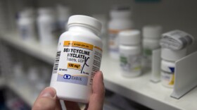 A pharmacist holds a bottle of the antibiotic doxycycline hyclate. The CDC has released data that show how chlamydia, gonorrhea and syphilis infections have been accelerating across the country. The agency is considering recommending doxycycline to be used after sex to prevent those infections.