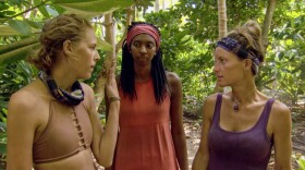 Angela Perkins (right) talks strategy with Laurel Johnson (center) and Kellyn Bechtold (left).