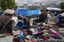 In this Tuesday, Aug. 25, 2015, file photo, clothes that belong to homeless people are left to dry after a night with heavy rain at a homeless encampment in the Kakaako district of Honolulu. The camp, one of the nation's largest homeless encampments and once home to hundreds of people, was recently cleared by city and state officials. Hawaii lawmakers are unveiling a package of bills designed to create affordable housing and alleviate homelessness. (AP Photo/Jae C. Hong, File)