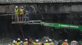 Crews work at the site of a collapsed elevated section of Interstate 95 in Philadelphia, June 14, 2023. The highway was set to reopen to traffic Friday, June 23, less than two weeks after the collapse shut down a heavily traveled stretch of the East Coast’s main north-south highway. Workers were putting the finishing touches on an interim six-lane roadway that will serve motorists during construction of a permanent bridge.