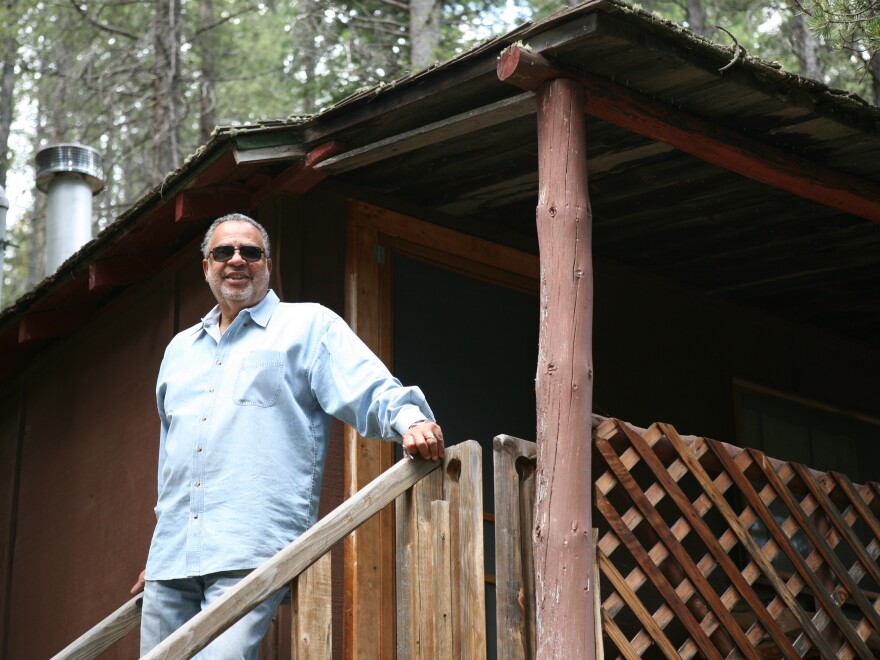 Gary Jackson on the back steps of the Lincoln Hills cottage his great-grandfather built in 1926.
