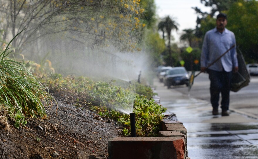 Sprinklers water plants in front of an apartment complex in South Pasadena, Calif., in January. Despite the drought, many lawns are still green, and fountains are still running.