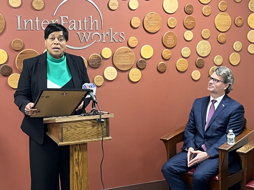 Syracuse Mayor Sharon Owens reads a proclamation marking the April 1 anniversary of Interfaith Works as President and CEO Chris Foley looks on.