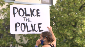 A protester holding a sign outside the Monroe County Courthouse on June 9, 2020