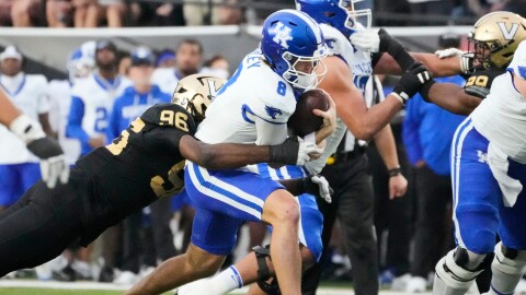 Vanderbilt defensive lineman Khordae Sydnor (96) tackles Kentucky quarterback Cutter Boley (8) during the first half of an NCAA college football game Saturday, Nov. 22, 2025, in Nashville, Tenn. (AP Photo/George Walker IV)
