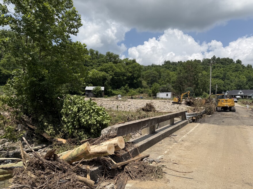 A volunteer helps clear debris from a section of roadway off Tates Creek Road in Madison County, Ky., June 29, 2026, after flash flooding in the area left three people dead.