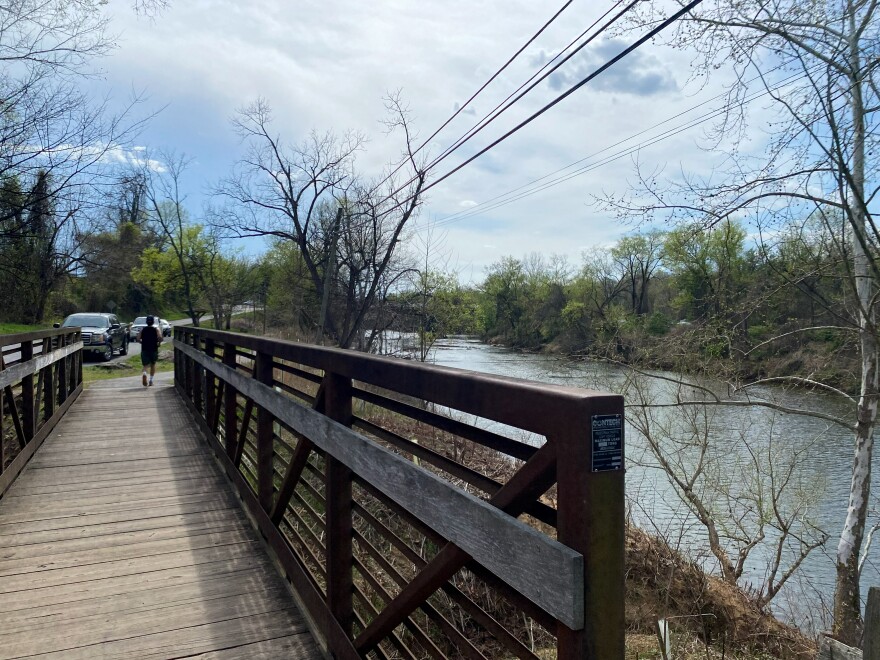 A jogger on the Albemarle County side of the Rivanna, where camping is prohibited.