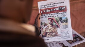 A man buys a newspaper with theh the picture of Paul-Henri Sandaogo Damiba the leader of the mutiny and of the Patriotic Movement for the Protection and the Restauration (MPSR) in Ouagadougou.