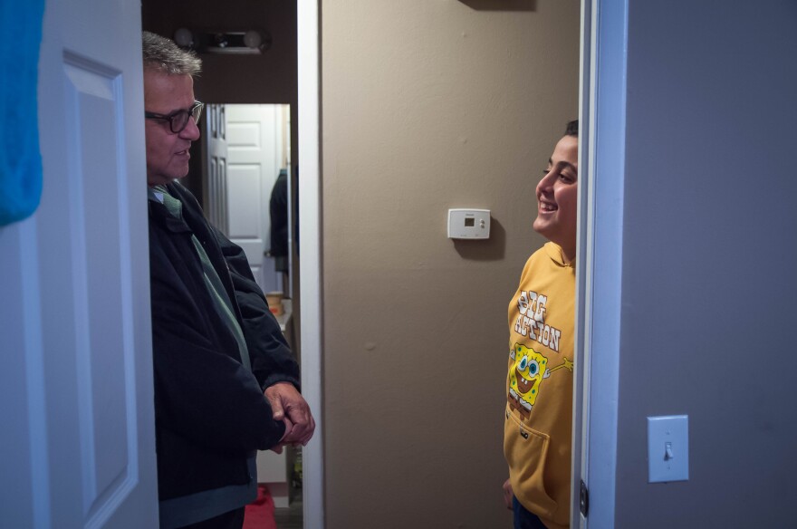 Basem Hamdan speaks with his son, Radi, at their home in Florissant. Radi and his twin 12-year-old brother, Hadi, moved to the north St. Louis suburb last summer to be with their father. They said their English would be improving father if they got more t