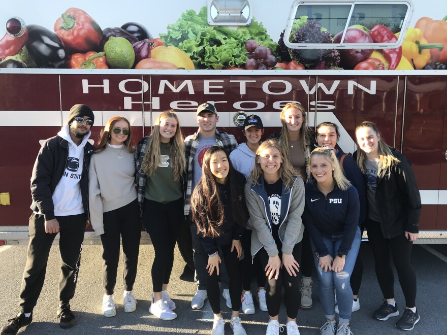 Volunteers in front of the YMCA's Hometown Heroes firetruck, which serves as a mobile feeding unit.