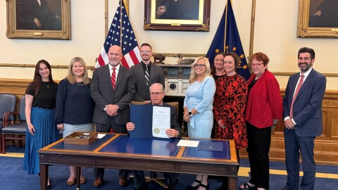 Indiana Gov. Mike Braun (R) takes part in a ceremonial signing of a bill to ban crypto currency ATMs